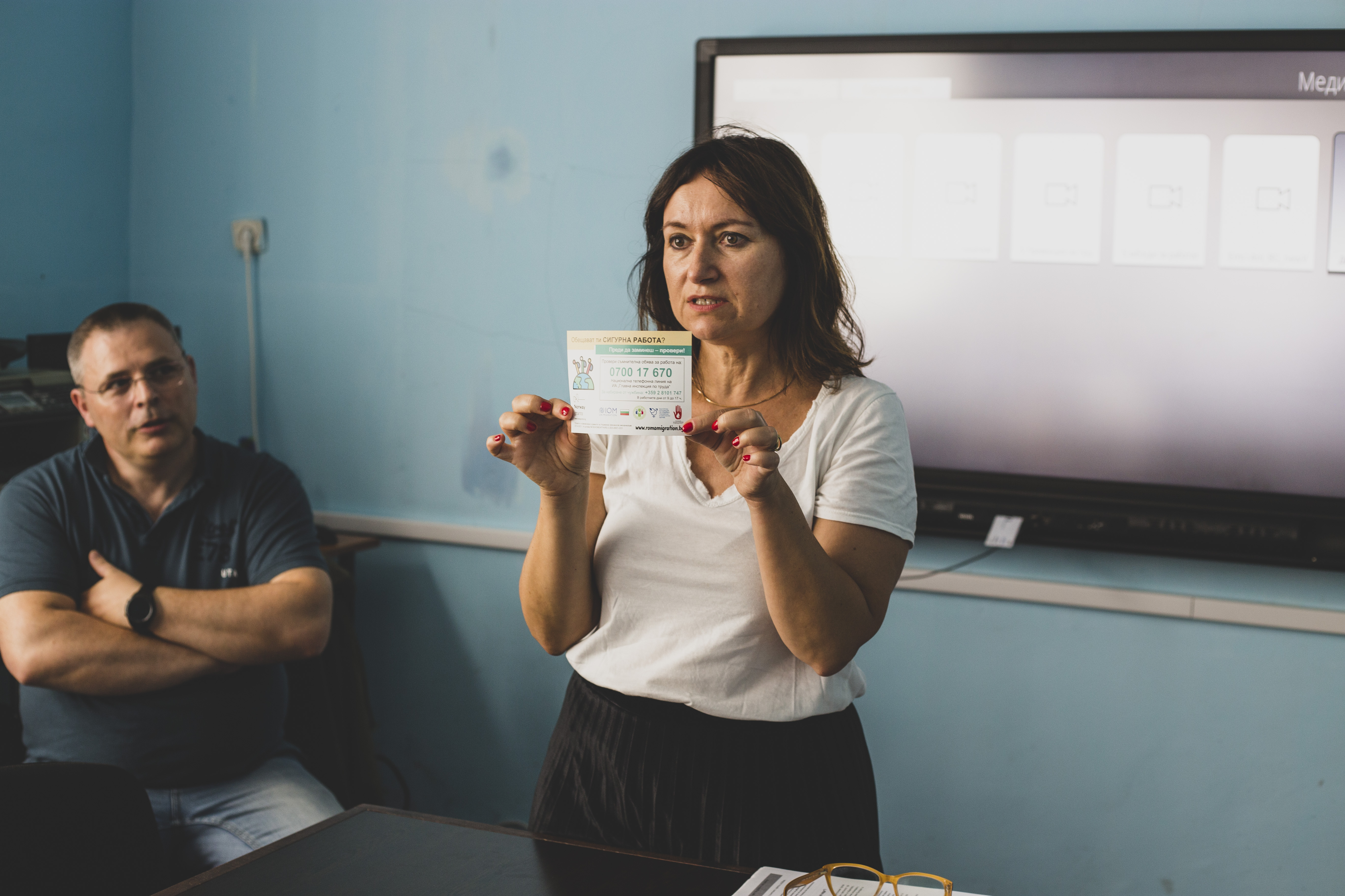 One of the presenters showing a brochure 