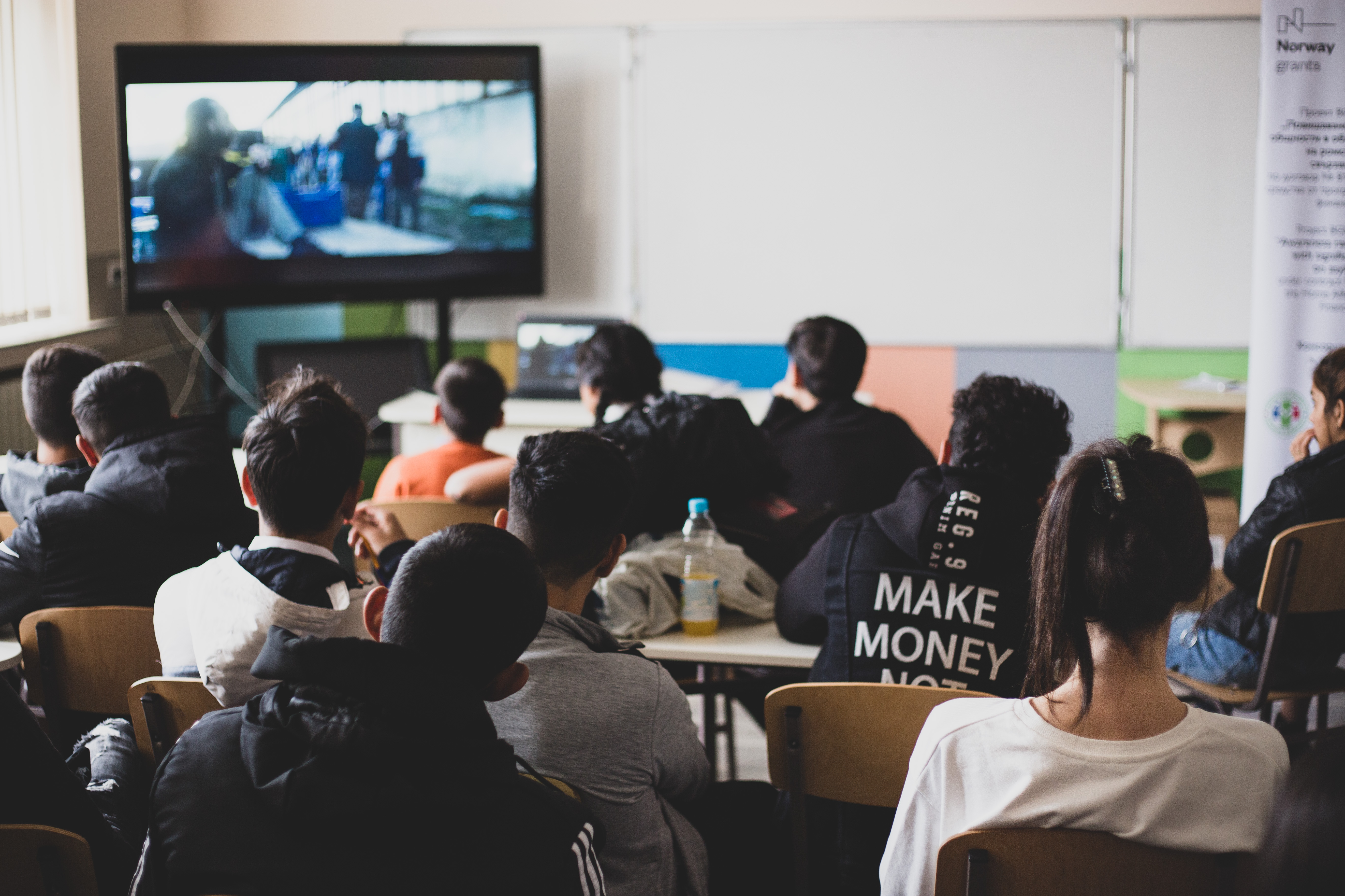 Students watching an informational video on trafficking in human beings